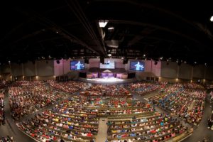 Falls Creek Conference Center auditorium fills with college students for the retreat.