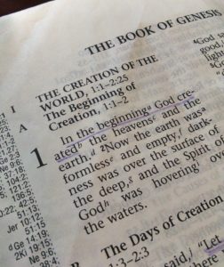 The first page of Genesis from the Bible. "In the beginning" is underlined.