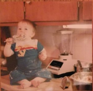 My little boy sitting on the kitchen counter, covered in flour from "helping" mom mix up the cookies.