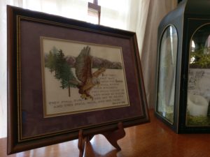 A framed cross stitched picture of an eagle in flight. The verse below it is Isaiah 40:31